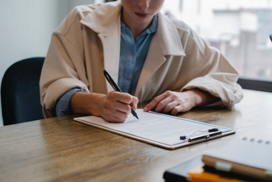 A woman writing on a paper