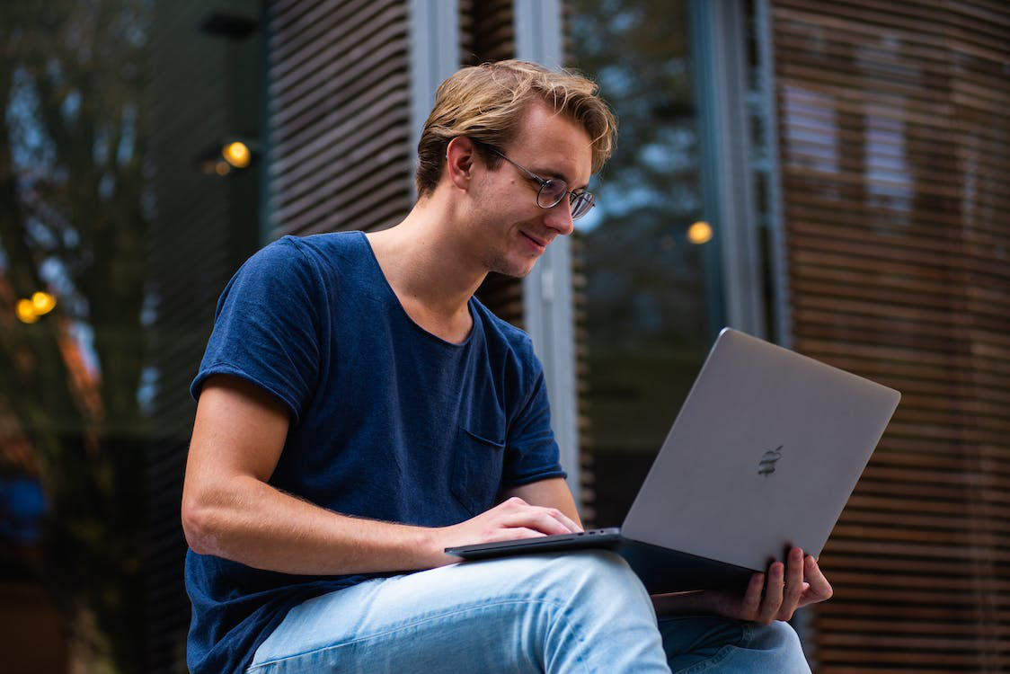 Person smiling at a laptop