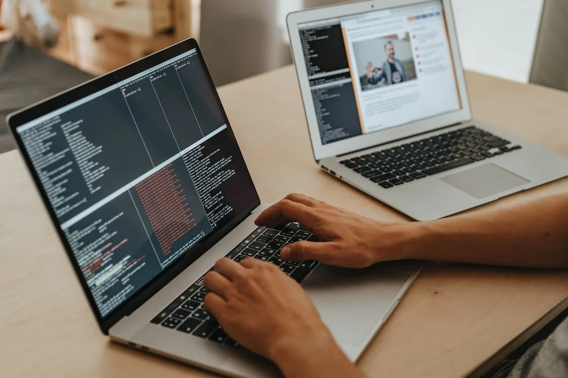 A person programming a website on their laptop