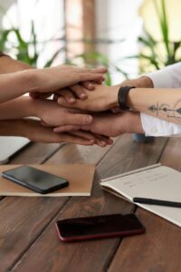 People putting their hands together in a circle