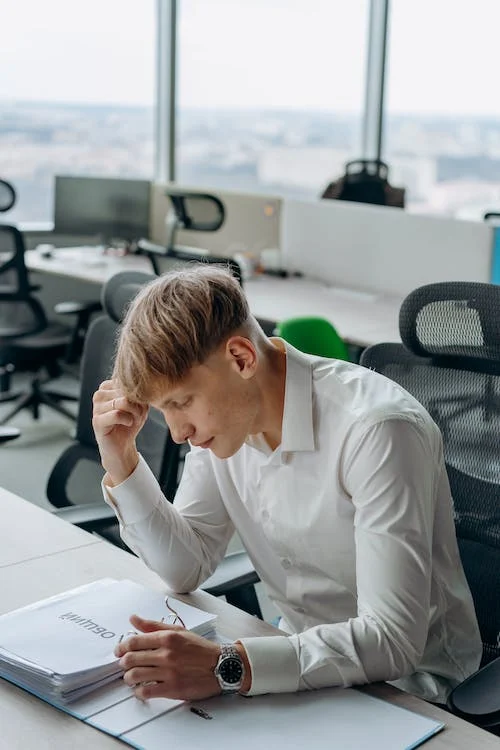 An image of a man looking at a file  