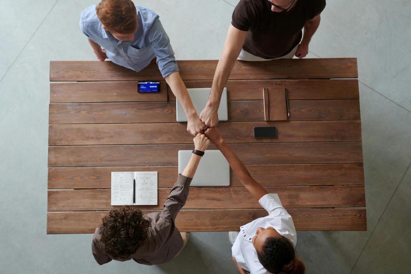 People in a team doing a fist bump