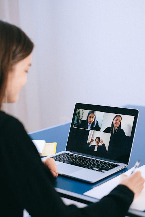 Four female employees having an online meeting for an IT project