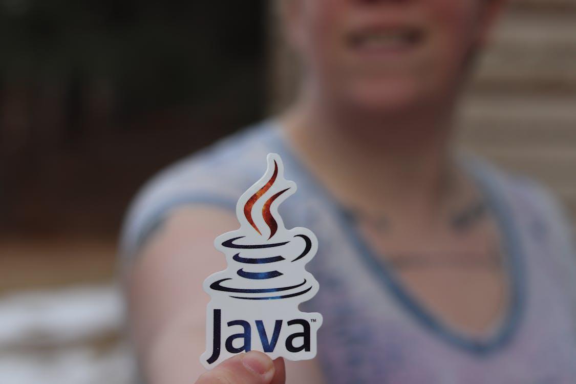 An image of a person holding a Java sticker