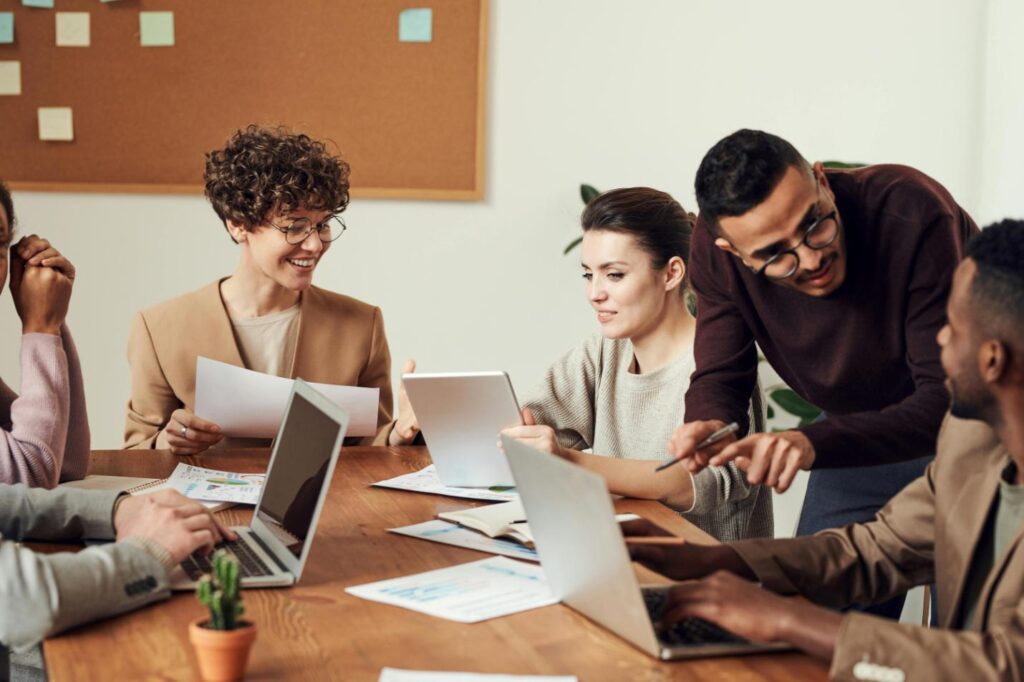 A picture of a group of employees sitting around a wooden table